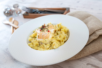 tasty pasta with salmon on a the table