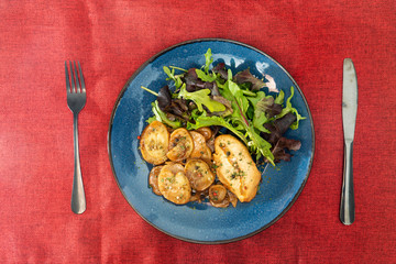 close-up of plate of pasta and chicken with lettuce