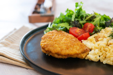 Italian food macaroni gratin with ham on table
