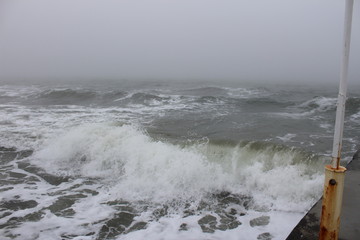 Sea storm in cold winter morning and fog