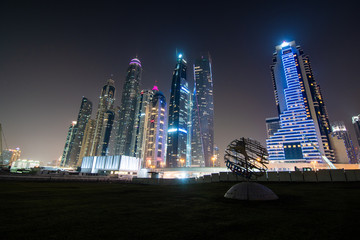 Dubai, United Arab Emirates - October, 2018: Colorful city lights at night time in Dubai Marina, United Arab Emirates