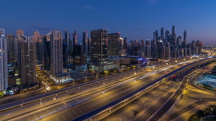 Fototapeta na wymiar Dubai Marina skyscrapers aerial top view before sunrise from JLT in Dubai night to day timelapse, UAE.
