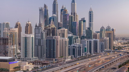 Dubai Marina skyscrapers aerial top view before sunrise from JLT in Dubai night to day timelapse, UAE.