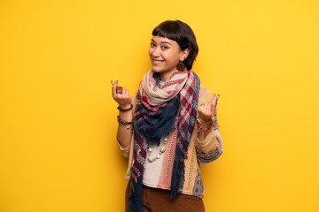 Young woman with short hair making money gesture