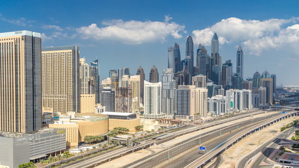 Naklejka na ściany i meble Dubai Marina skyscrapers aerial top view with clouds from JLT in Dubai timelapse, UAE.