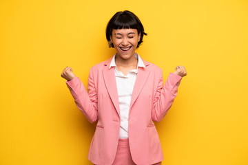 Modern woman with pink business suit shouting to the front with mouth wide open