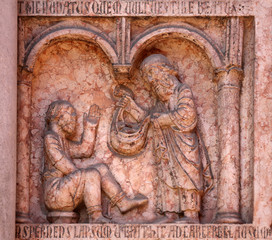 Christ Performing Works of Mercy relief at the baptistry from Benedetto Antelami, Parma, Emilia Romagna, Italy