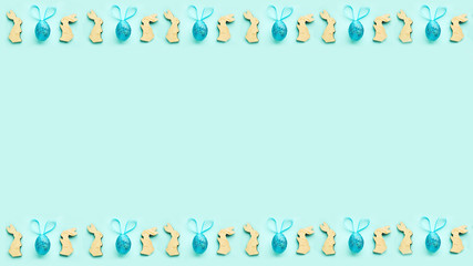 colorful background for easter, wooden bunnies and Easter eggs with ears