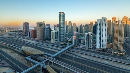 Fototapeta na wymiar Dubai Marina skyscrapers aerial top view at sunrise from JLT in Dubai timelapse, UAE.