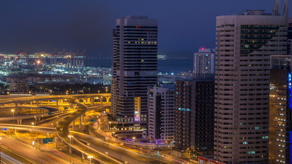 Dubai Marina skyscrapers aerial top view before sunrise from JLT in Dubai night to day timelapse, UAE.