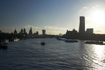 Fototapeta premium Residents and tourists exploring the city centre of London in early morning spring sunlight