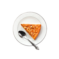 Top view of piece of pumpkin pie with walnuts on a plate isolated on white background with clipping path