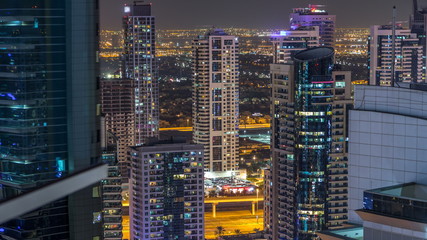Fototapeta na wymiar Dubai marina and JLT skyscrapers aerial skyline night timelapse.