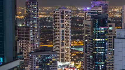 Dubai marina and JLT skyscrapers aerial skyline night timelapse.
