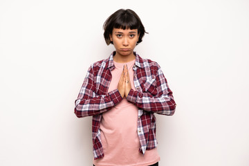 Young woman with short hair keeps palm together. Person asks for something