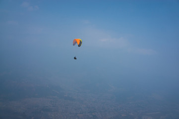 Paragliders in the sky. Flight in tandem with an instructor. Extreme sport. Pokhara Nepal 