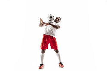 Obraz premium Professional african american football soccer player in motion isolated on white studio background. Fit jumping man in action, jump, movement at game.