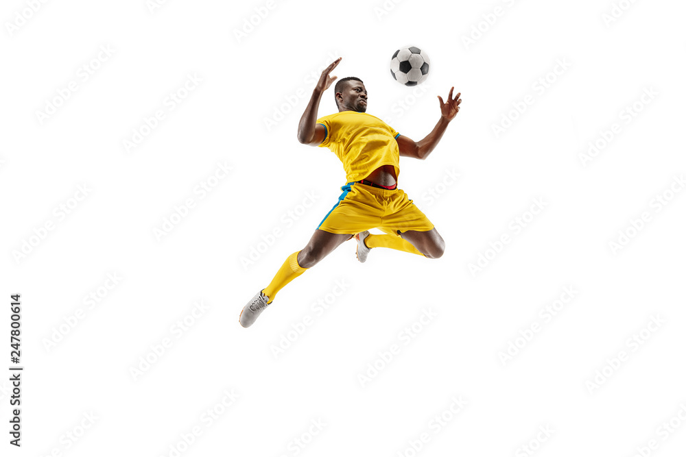 Wall mural professional african american football soccer player in motion isolated on white studio background. 