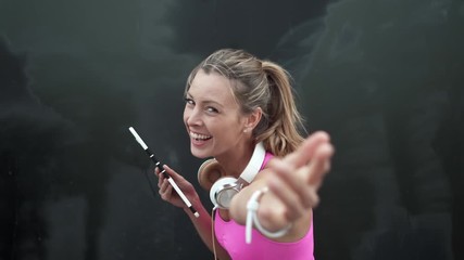 Fitness instructor with tablet signing you up for gym membership on black background