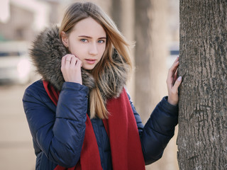 Portrait of young woman at sunny winter day.