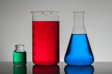 Liquid in laboratory bottles. Scientific biochemical laboratory. Colorful liquid.