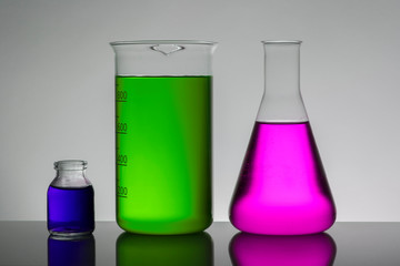 Liquid in laboratory bottles. Scientific biochemical laboratory. Colorful liquid.