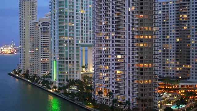 Slow motion pan of downtown Miami lit up in evening