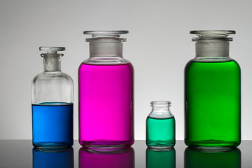 Liquid in laboratory bottles. Scientific biochemical laboratory. Colorful liquid.