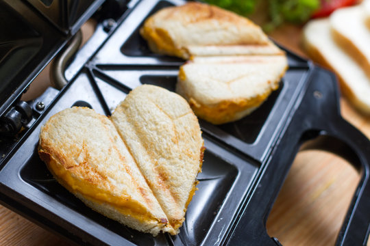 Toast heart shape with toaster sandwich maker love valentines breakfast concept