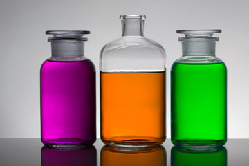 Liquid in laboratory bottles. Scientific biochemical laboratory. Colorful liquid.