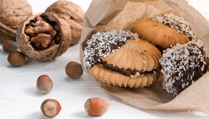 Obraz na płótnie Canvas .cookies with chocolate and nuts on a white wooden background
