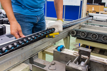 worker maintenance and repair conveyor belt in factory