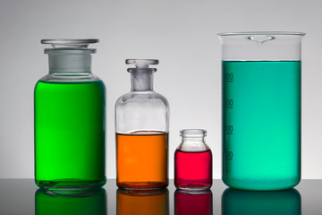 Liquid in laboratory bottles. Scientific biochemical laboratory. Colorful liquid.