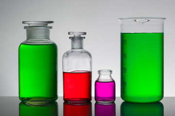 Liquid in laboratory bottles. Scientific biochemical laboratory. Colorful liquid.