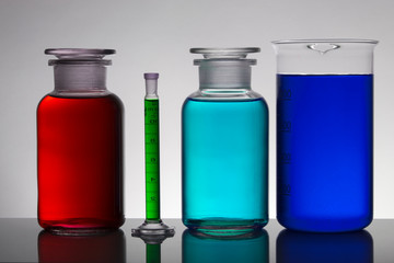 Liquid in laboratory bottles. Scientific biochemical laboratory. Colorful liquid.