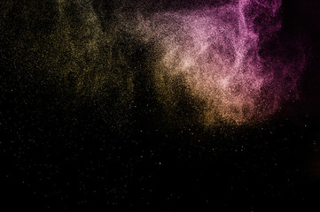 gold and purple powder effect splash for makeup artist or graphic design in black background