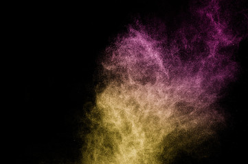 gold and purple powder effect splash for makeup artist or graphic design in black background