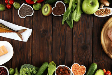 Healthy food clean eating selection. fruit, vegetable, seeds, superfood, cereals, leaf vegetable on rustic background