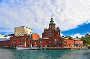 helsinki orthodox chatedral, old docks with red bricks buildings and landscape with summer clouds,...