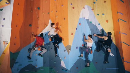 Training people in a climbing center, close up.