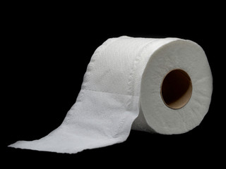 Tissue paper with roll core. Roll of toilet paper isolated on a black background.