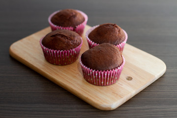 chocolate muffins on wooden board