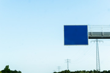 Empty road sign on the motorway Blue in summery atmosphere on a motorway in Germany
