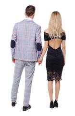 Back view of a hugging couple in evening outfits.