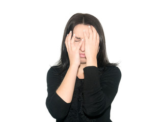 The woman in dark clothes covered her face with hands. She feels great fear. Girl isolated on white...