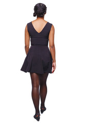 Fototapeta premium back view of a young black girl walking in dress.