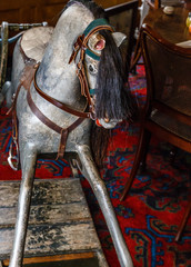 very old antique baby rocker gray with black hair, saddle