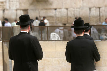 Jewish men pray at the western wall in Jerusalem, IL. The wall is one of the holiest sites in...