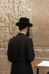 Jewish men pray at the western wall in Jerusalem, IL. 