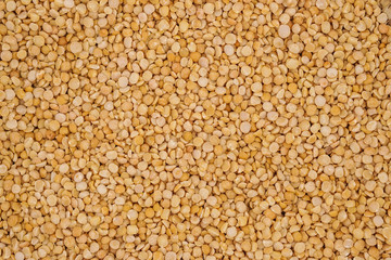 Dry yellow split peas background texture